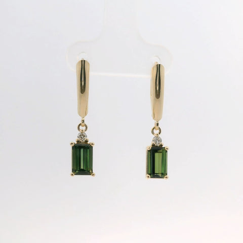 Earrings featuring emerald cut green stones with gold settings, front view