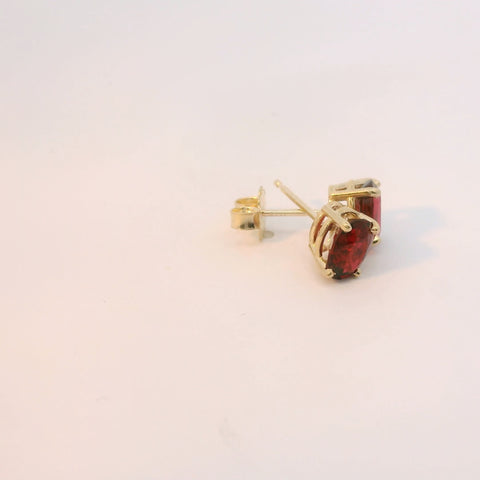 Gold earrings displayed from a different angle
