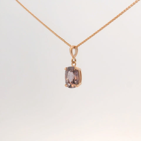 rose gold pendant featuring a purple gemstone, front view