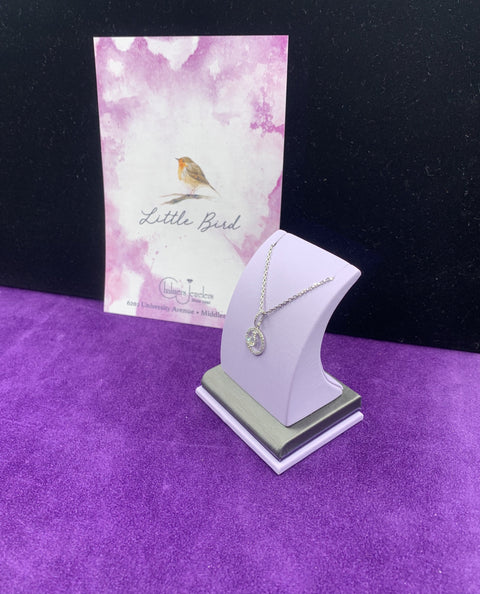 A gorgeous diamonds halo with a center diamond that dangles necklace. - Chalmers Jewelers